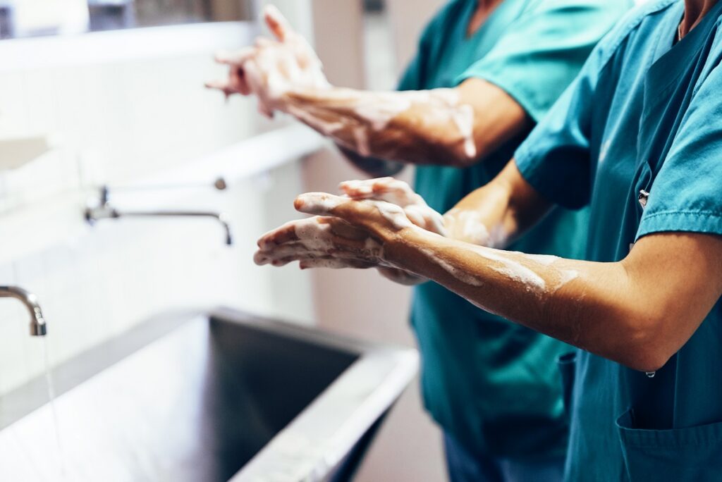 Photo of surgeons washing their hands as they battle burnout