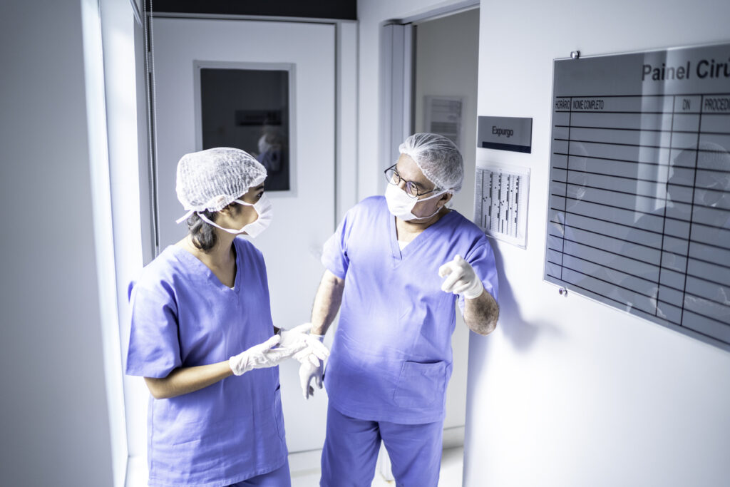Photo of a nurse and a doctor discussing patient care.