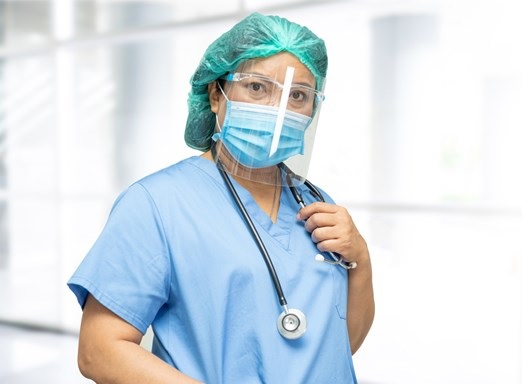 photo of a nurse looking stressed, perhaps she is in an environment that does not take psychological safety seriously